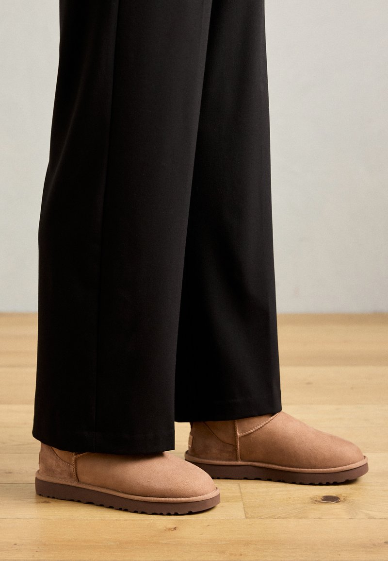 Uggs and Wide-Leg Trousers: A Neutral Pairing — Ugg Boots Outfits