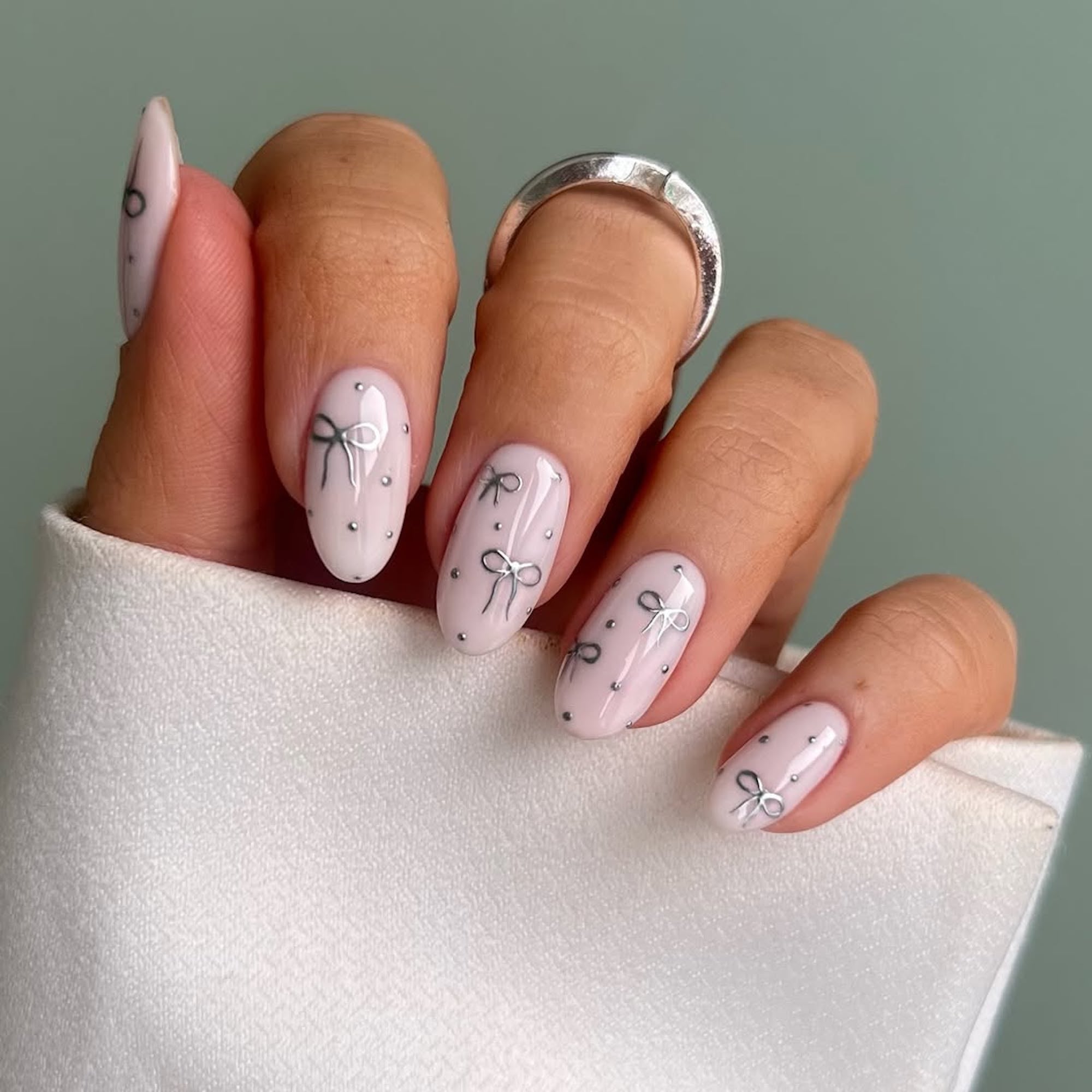 Pale Pink Bow Detail Oval Nails — Medium Length Winter Nails