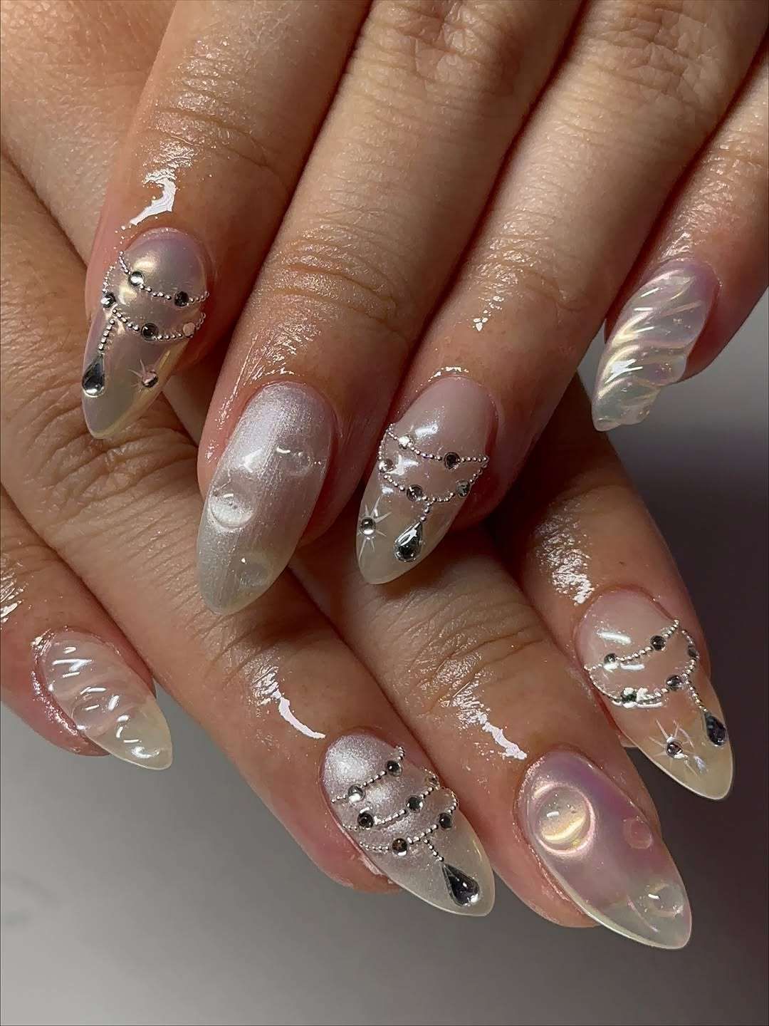 Long Stiletto Iridescent with Chains and Waves Long Stiletto Iridescent with Chains and Waves β Coquette Winter Nails