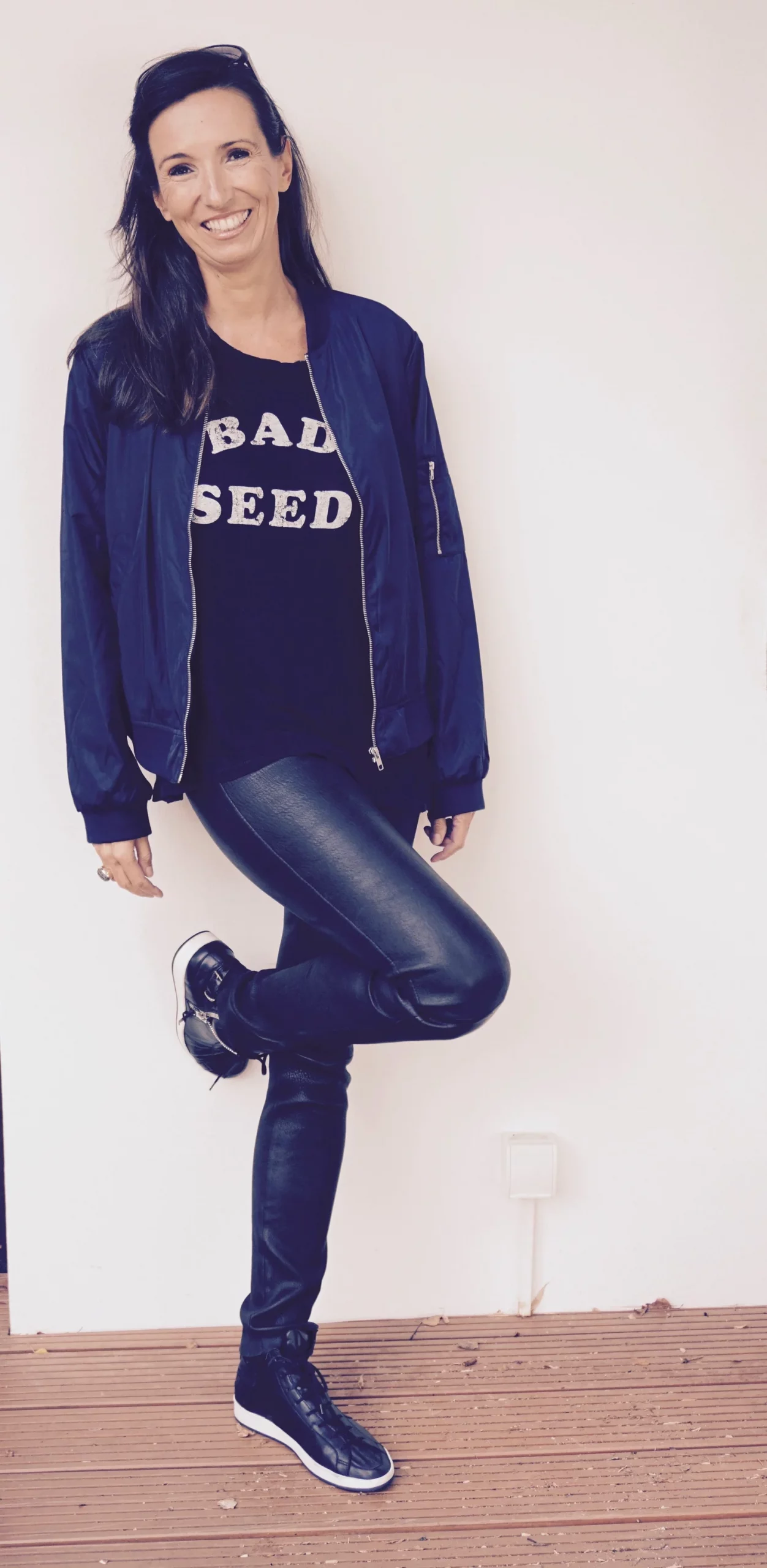 Black Leather Pants with Graphic Tee, Navy Bomber Jacket, and Leather Sneakers — Leather Pants Outfits