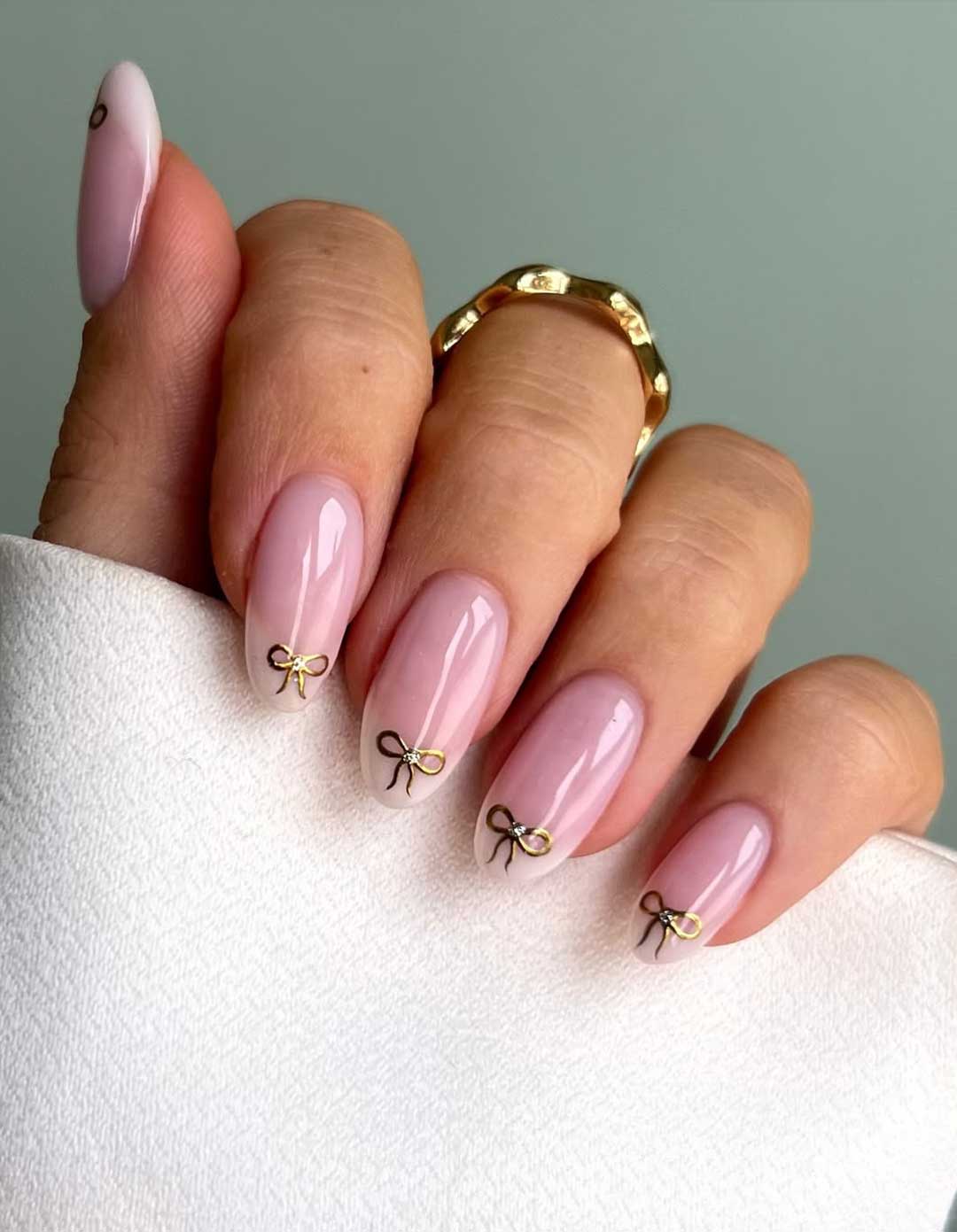 Sheer Pink Oval with Gold Bow Charms Sheer Pink Oval with Gold Bow Charms β New Years Almond Nails 2027