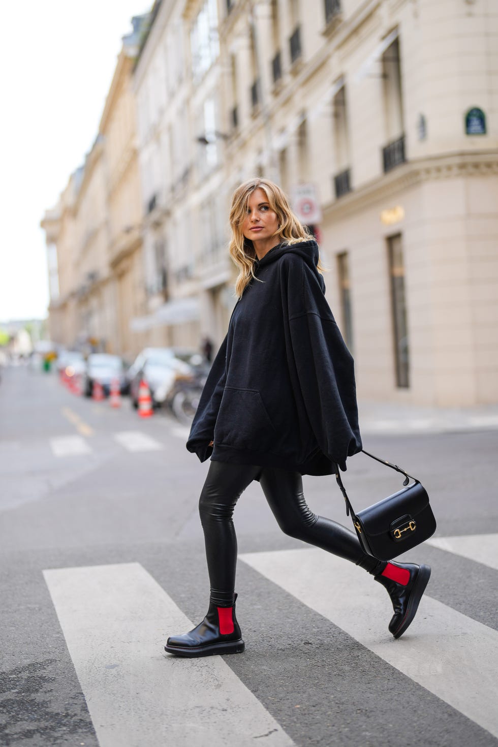 Streetwear Style: Oversized Hoodie, Leggings, and Boots with Red Accents — Winter Boots Outfits