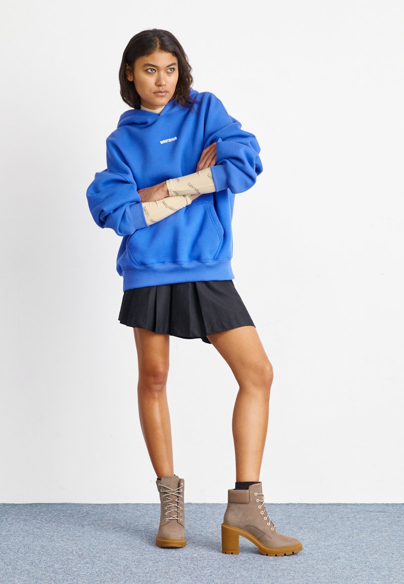 Heeled Timberlands with Mini Skirt and Arm Warmers — Timberland Boots Outfits