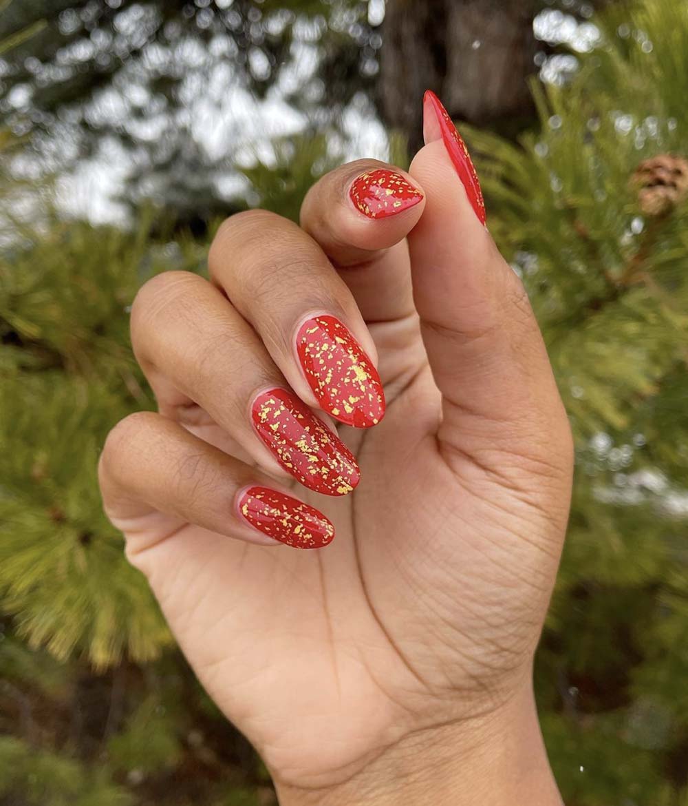 Glossy Red with Scattered Gold Foil Flakes Glossy Red with Scattered Gold Foil Flakes β Red and Gold Christmas Nails 2026