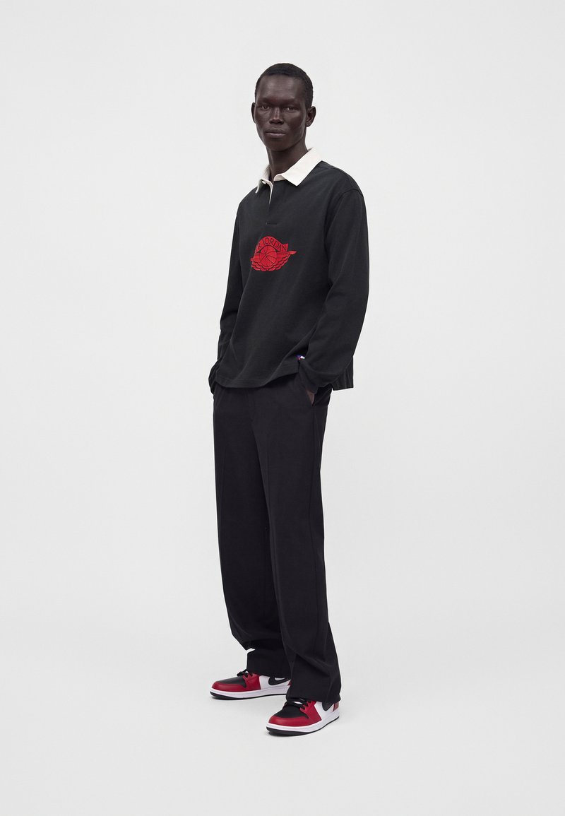 Graphic Long-Sleeve Polo with Relaxed Trousers — Chicago Winter Outfits