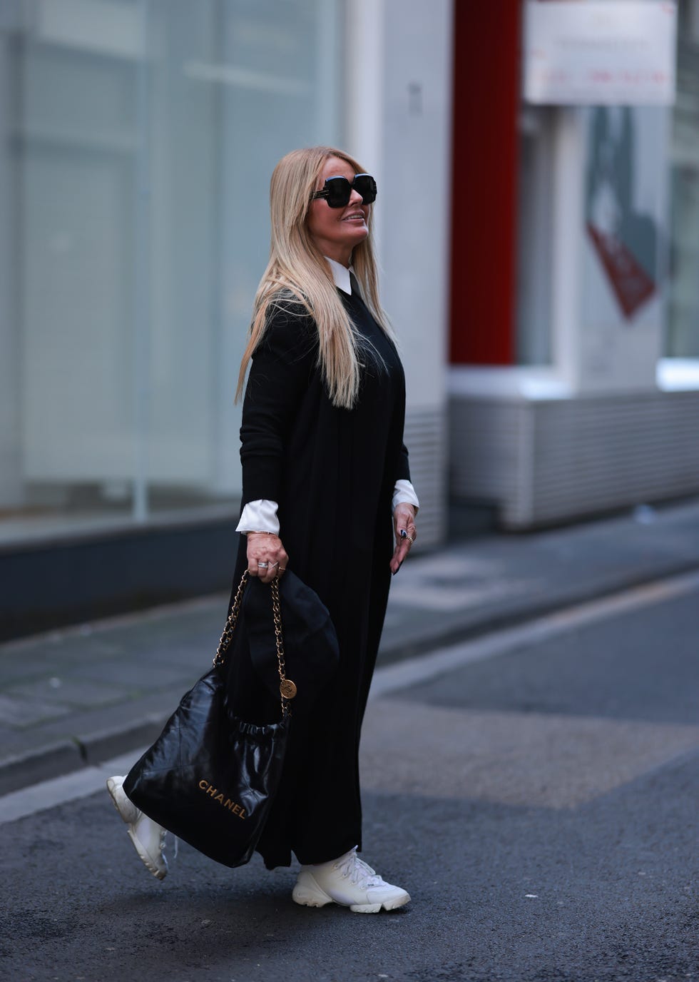 Long Black Dress Over a White Shirt with White Sneakers — Winter Outfits with Sneakers