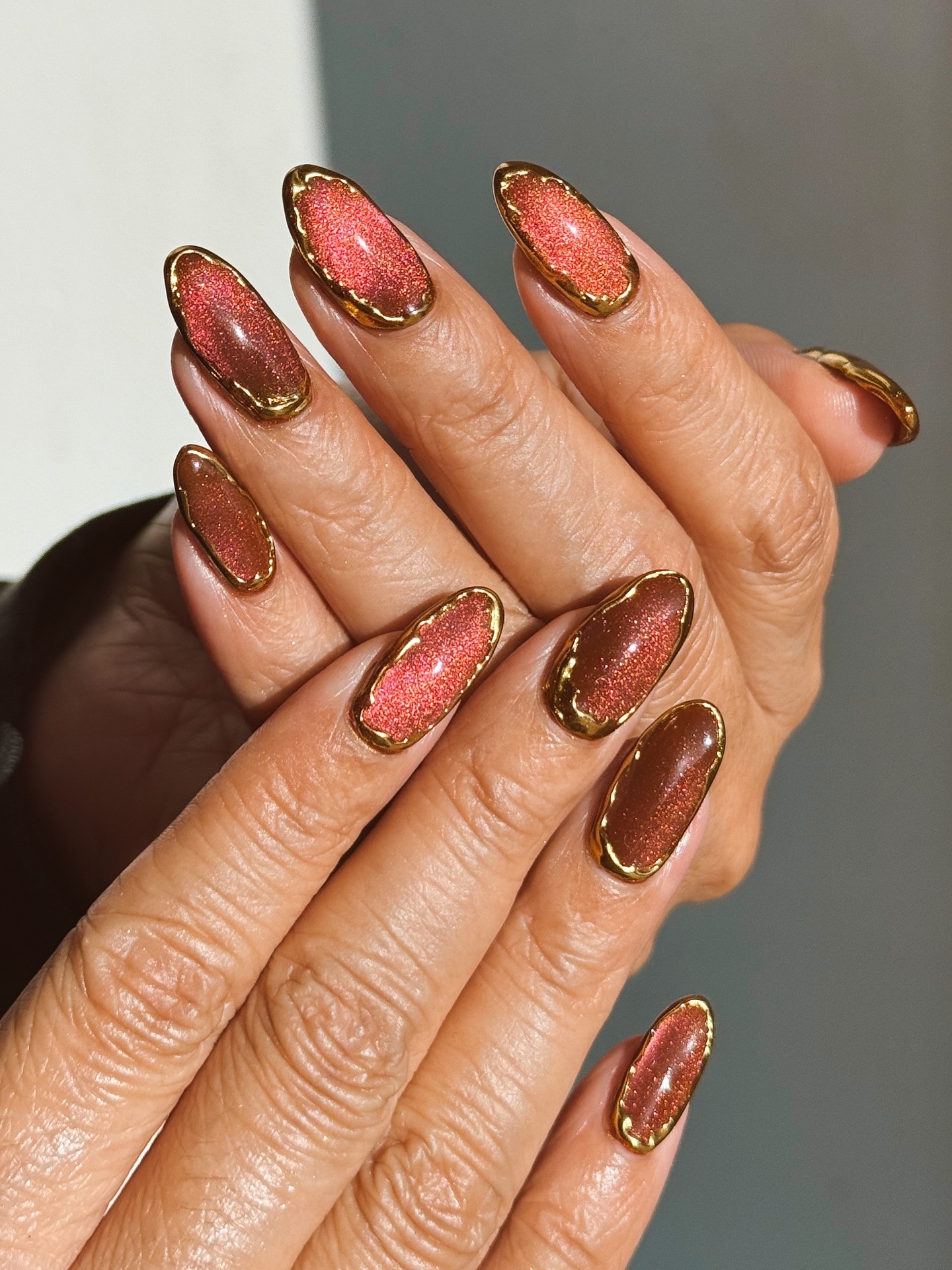 Warm Reddish-Brown Cat-Eye with Gold Border Warm Reddish-Brown Cat-Eye with Gold Border β Sparkly New Years Nails 2027