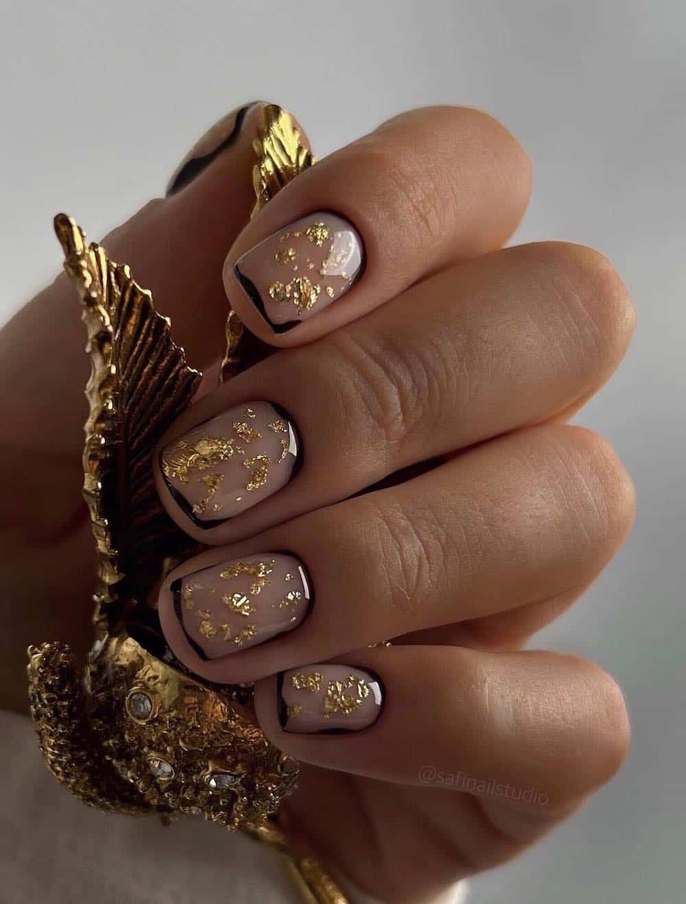 Sheer Nude with Gold Leaf and Black Outline — New Years Gel Nails 2027