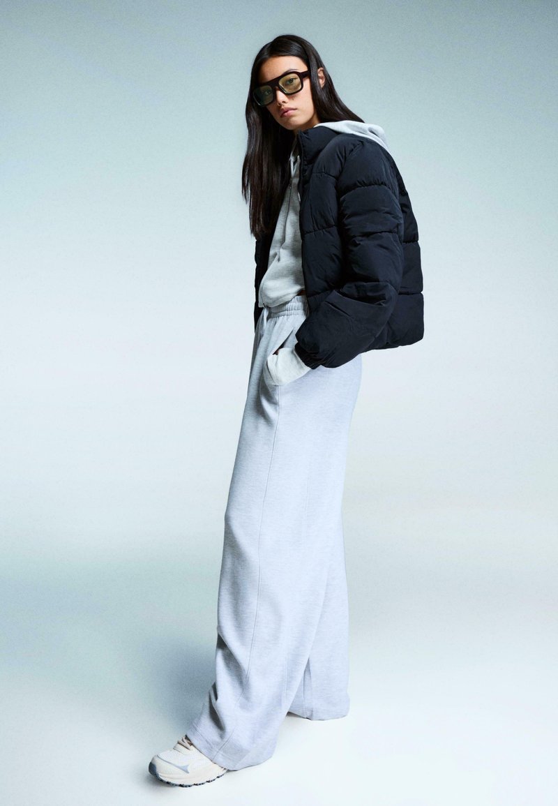 Black Puffer Jacket Over Hoodie with Wide-Leg Sweatpants — Winter Puffer Jacket Outfits