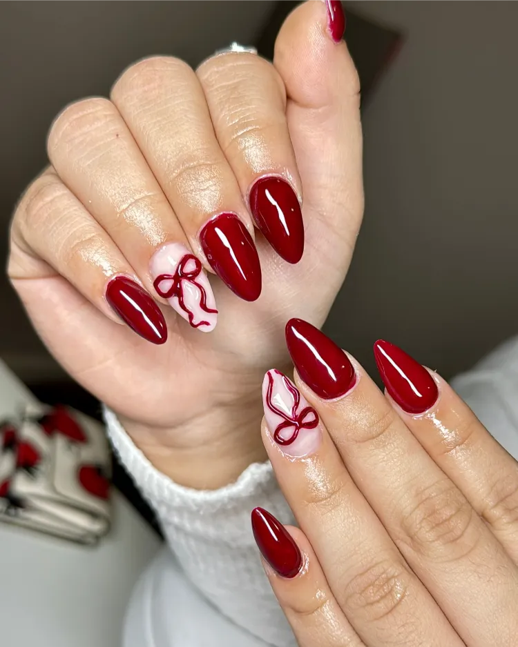 Deep Red with White Bow Accent Deep Red with White Bow Accent β Christmas Oval Nails 2026