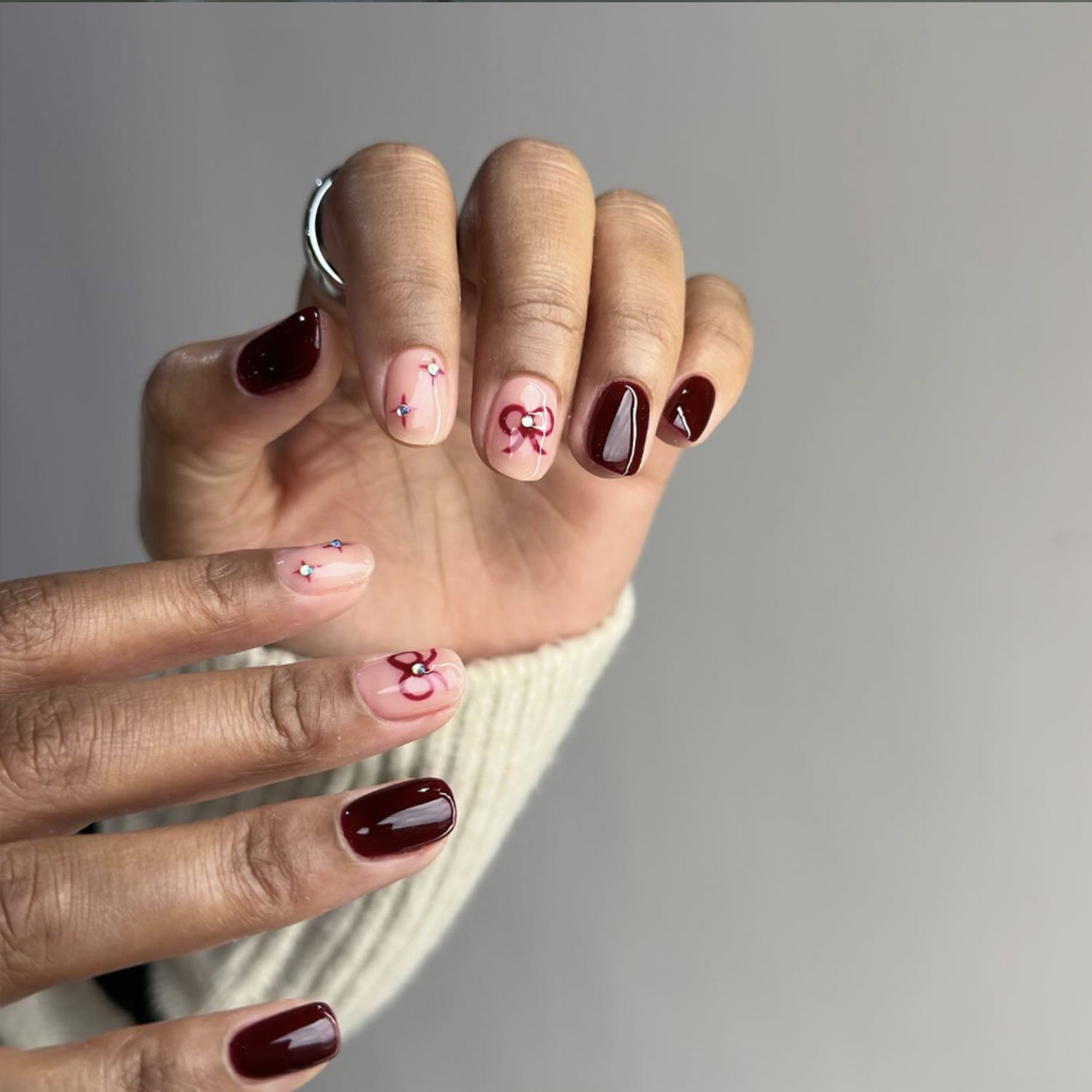 Burgundy Bows And Rhinestone Accent Nails — Winter Nail Colors for Women Over 60