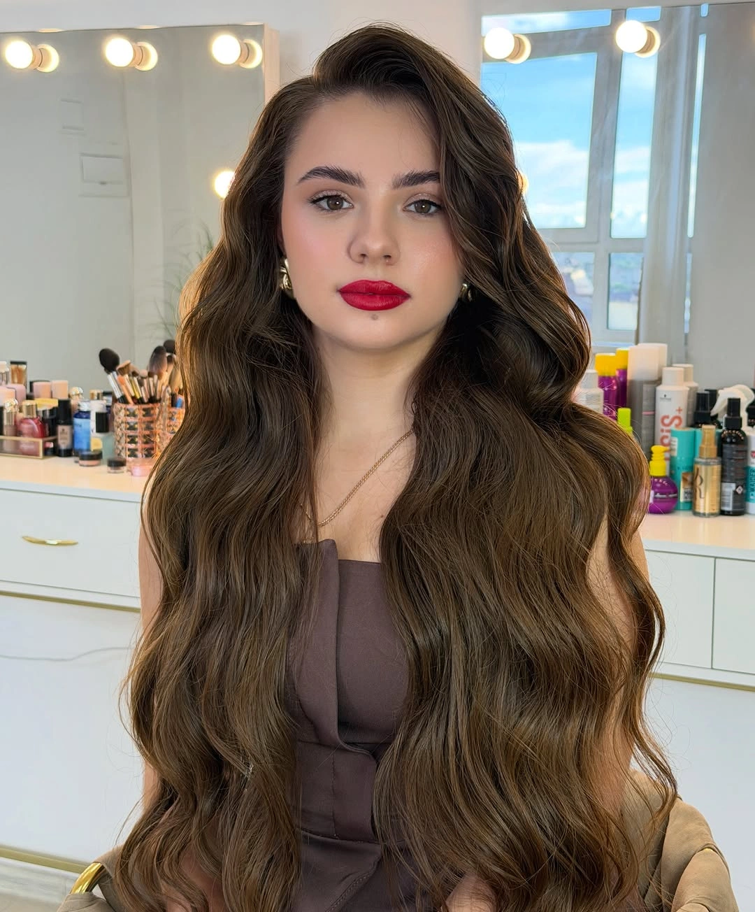 Very long brunette hair with side part and loose waves