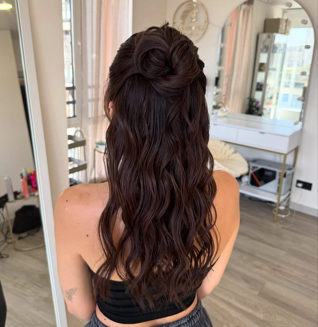 Long dark wavy hair with high half-up knot