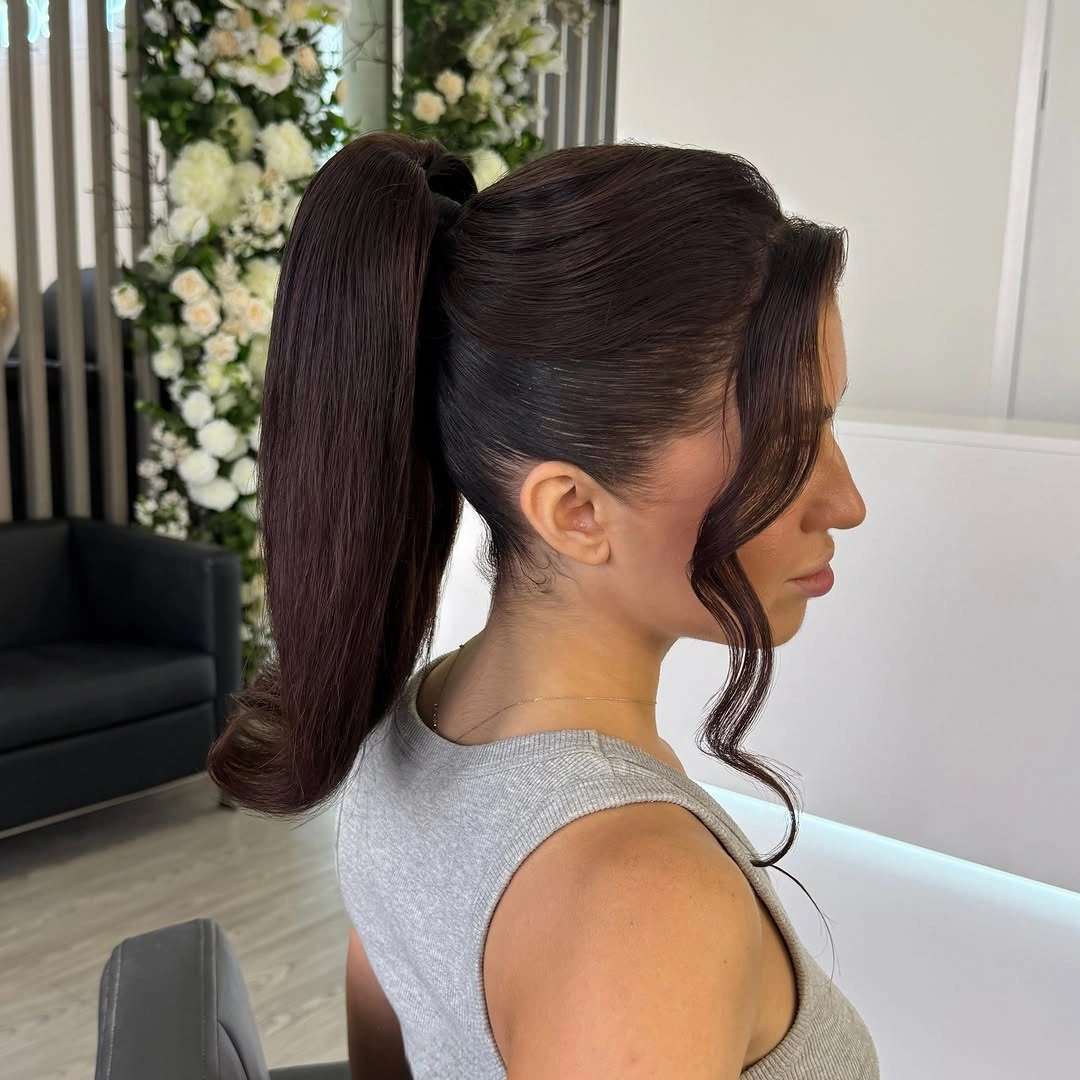 Sleek high ponytail with long curved face-framing section