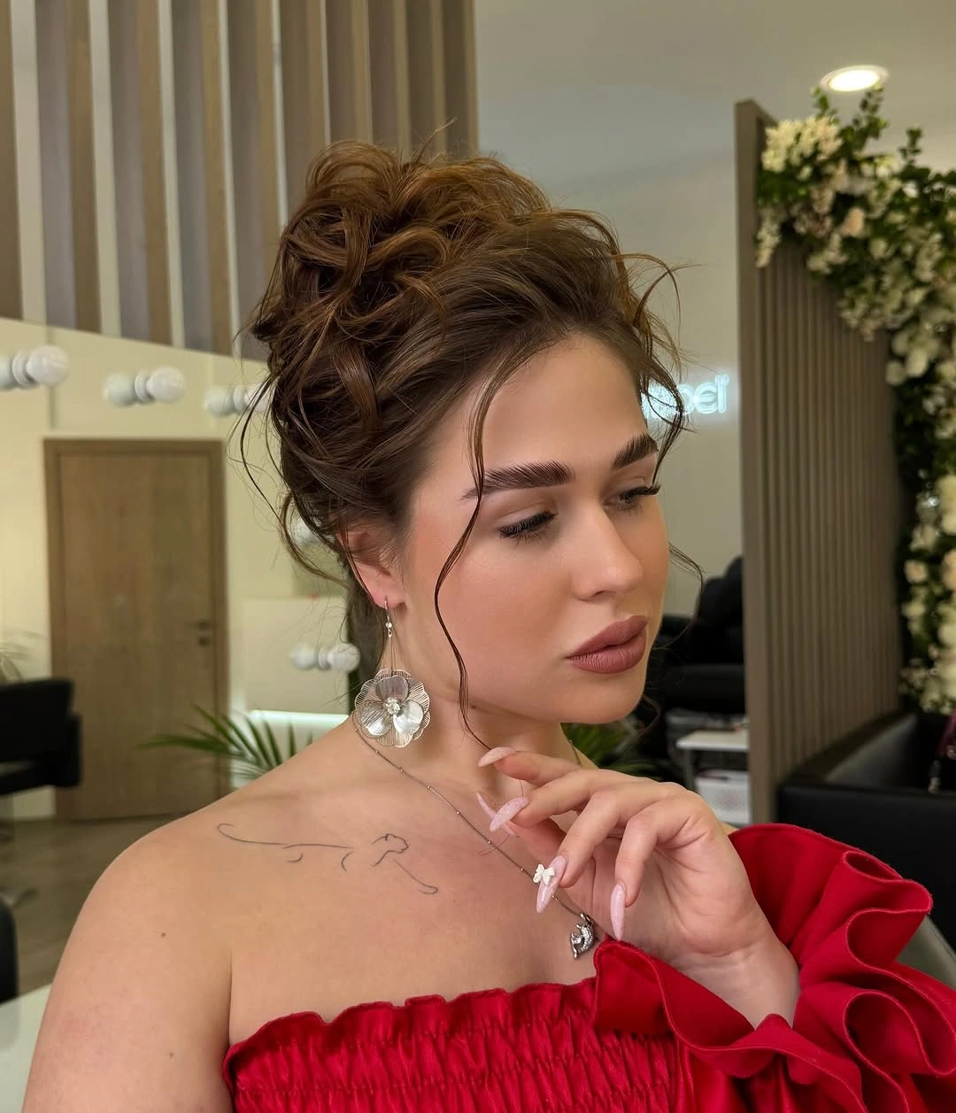 High warm brown updo with loose face-framing strands