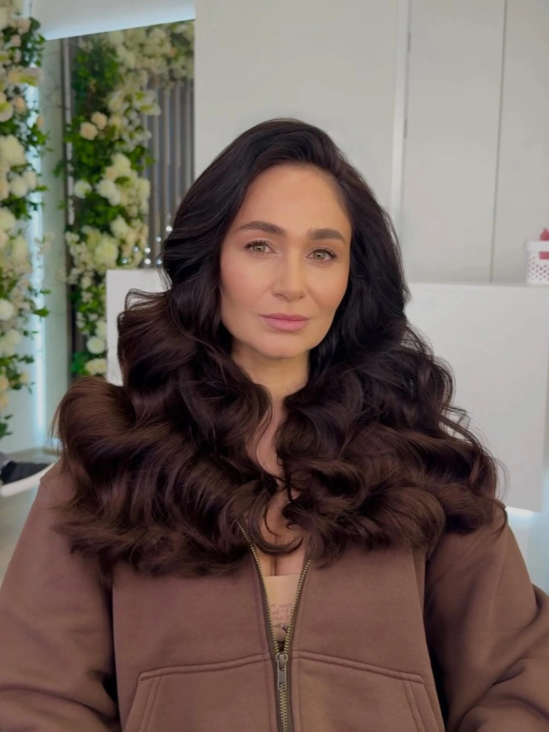 Long dark brown hair with deep part and rounded curls