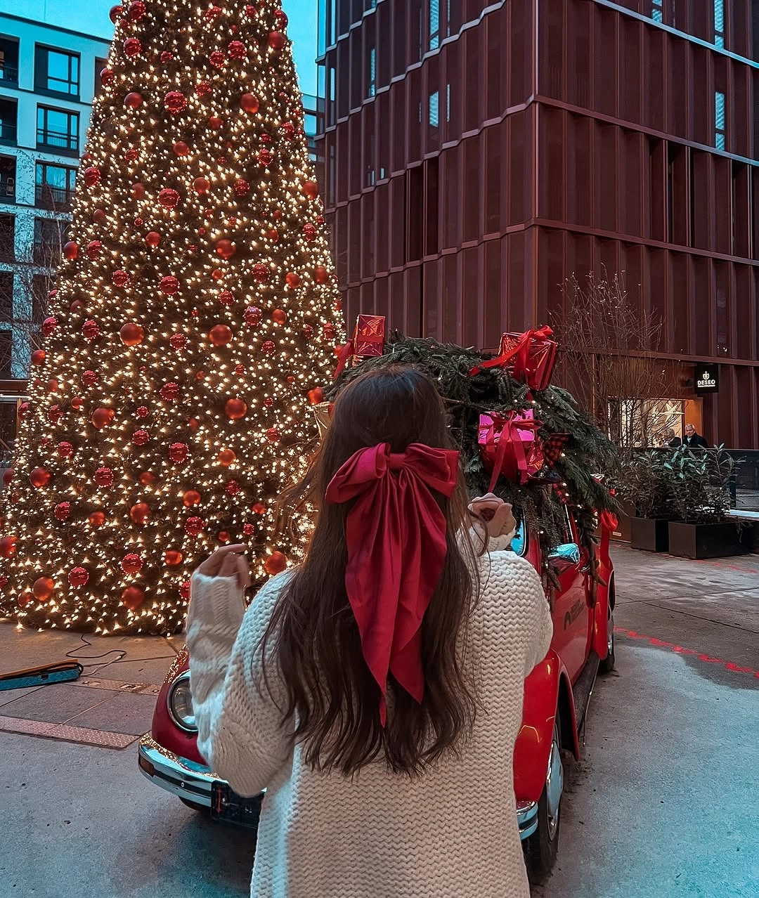 Long dark hair with oversized red bow at back