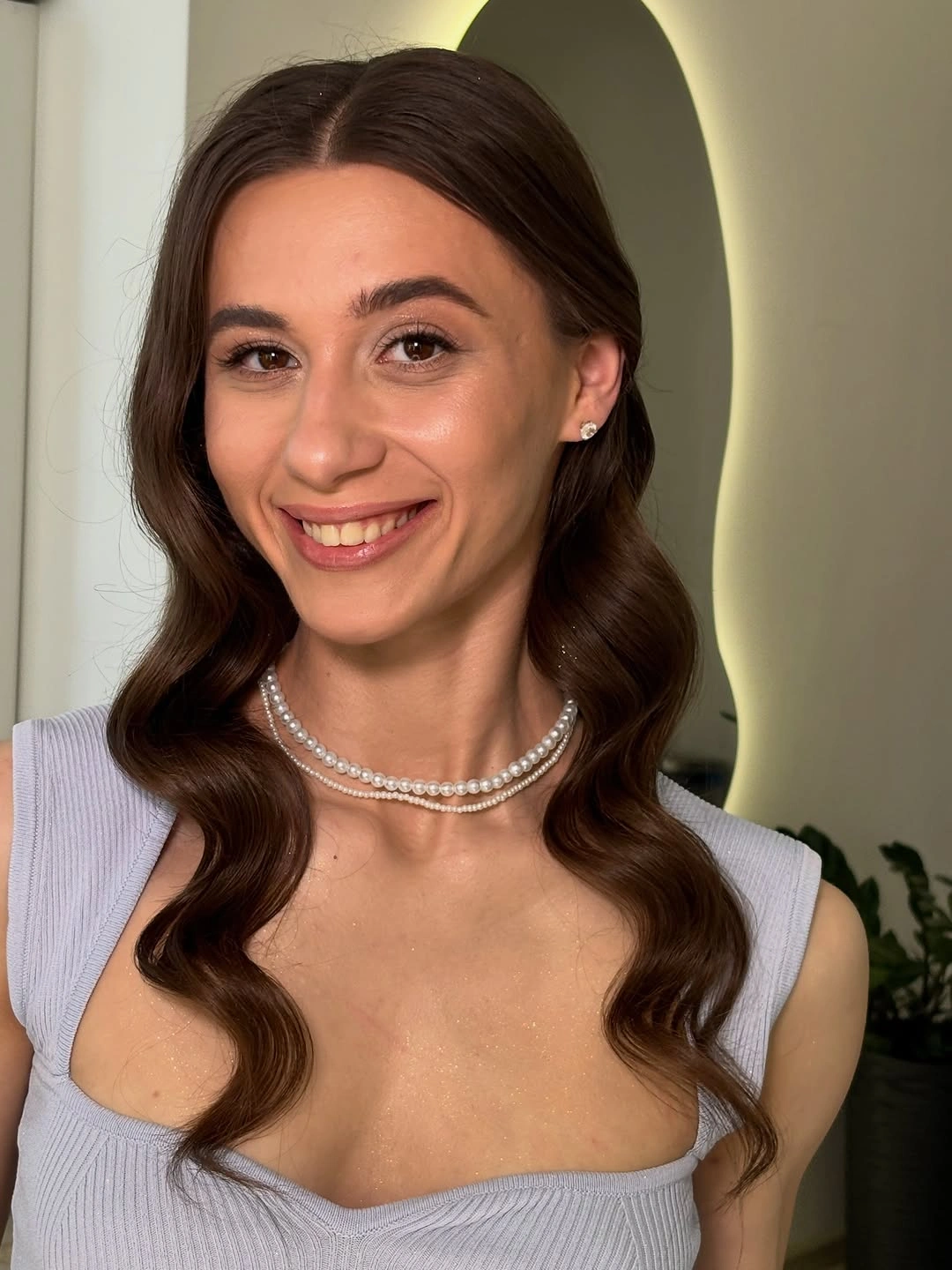 Long brown center-parted hair with symmetrical S-shaped waves