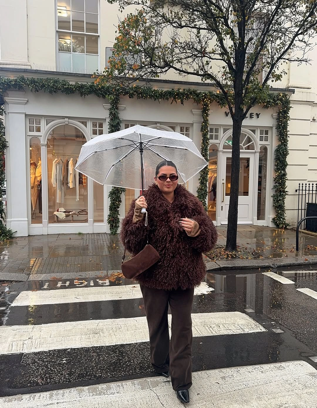Shaggy dark brown jacket with wide trousers pointed shoes and matching handbag