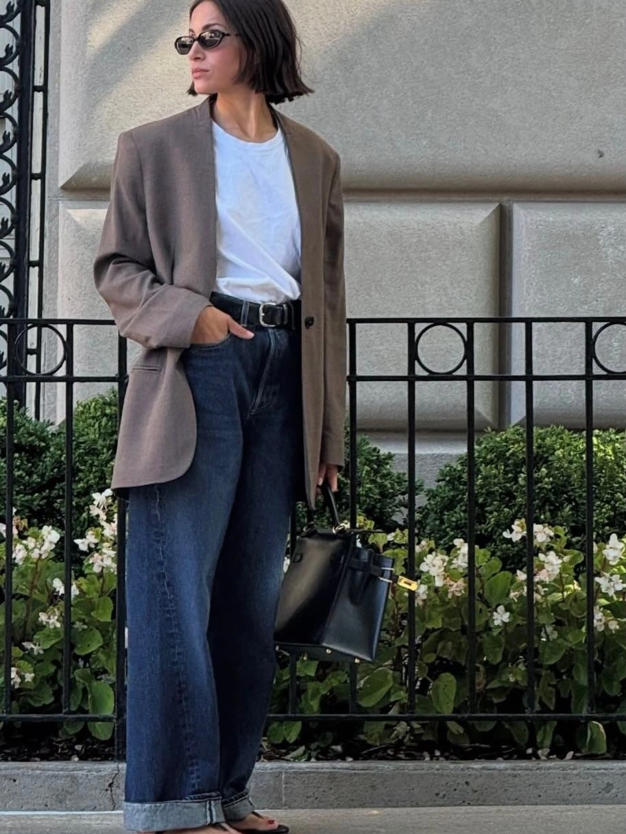 Taupe blazer white T-shirt cuffed jeans and black handbag