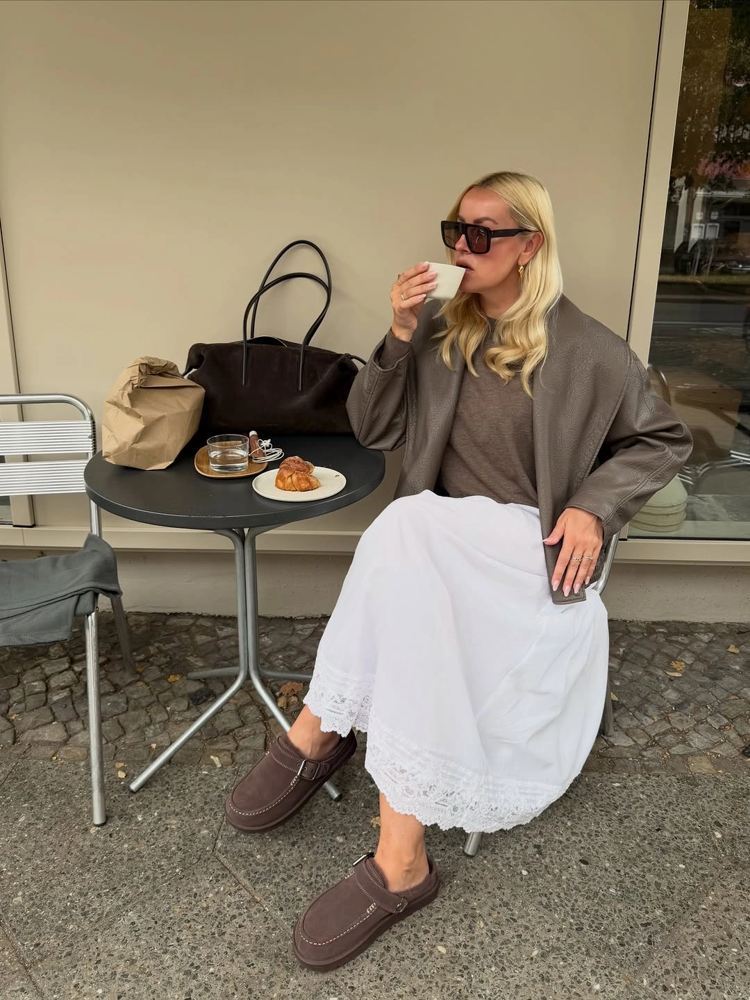 Gray-brown blazer white skirt brown loafers and dark tote