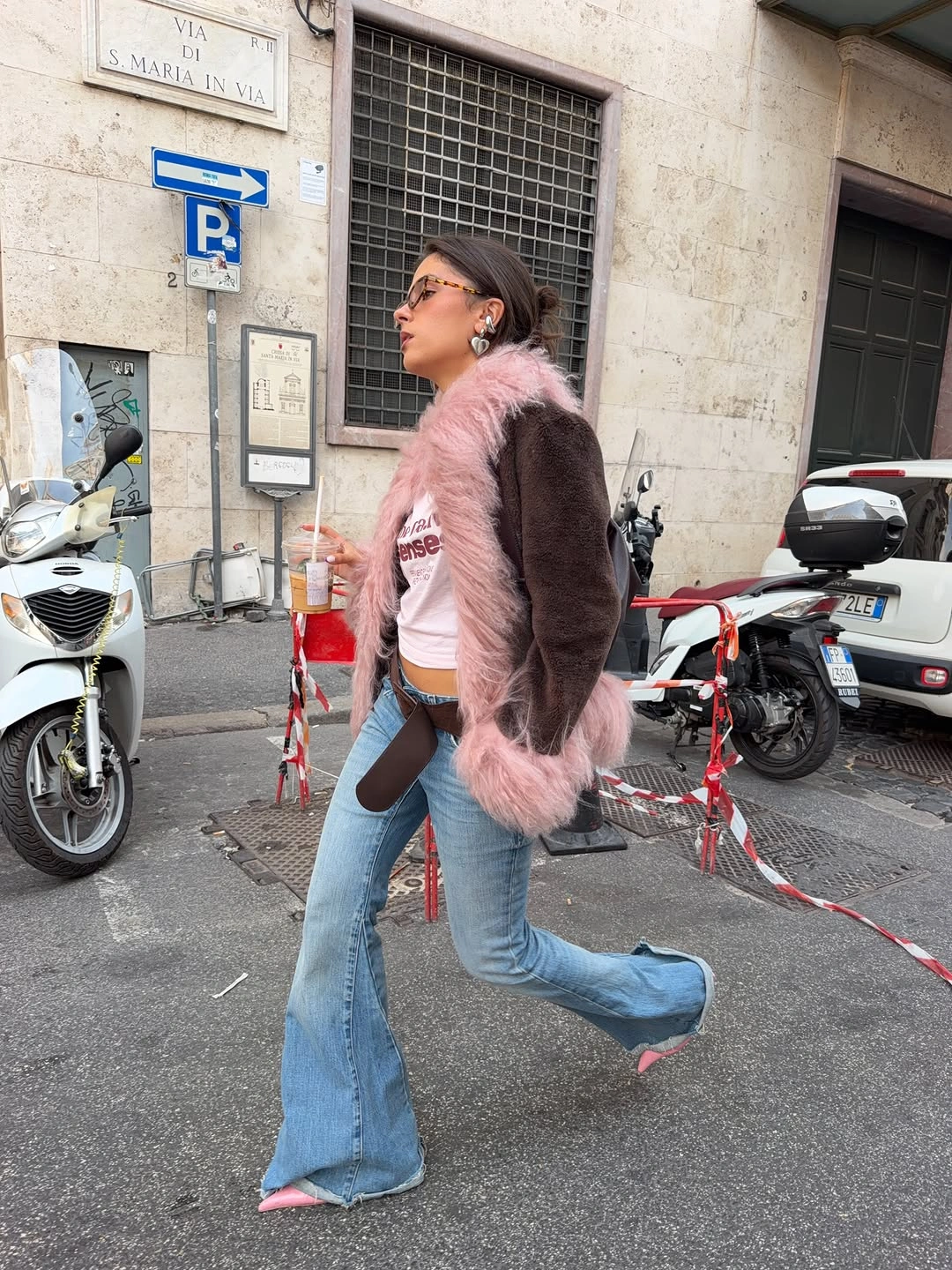 Brown jacket pink trim flared jeans and pointed shoes