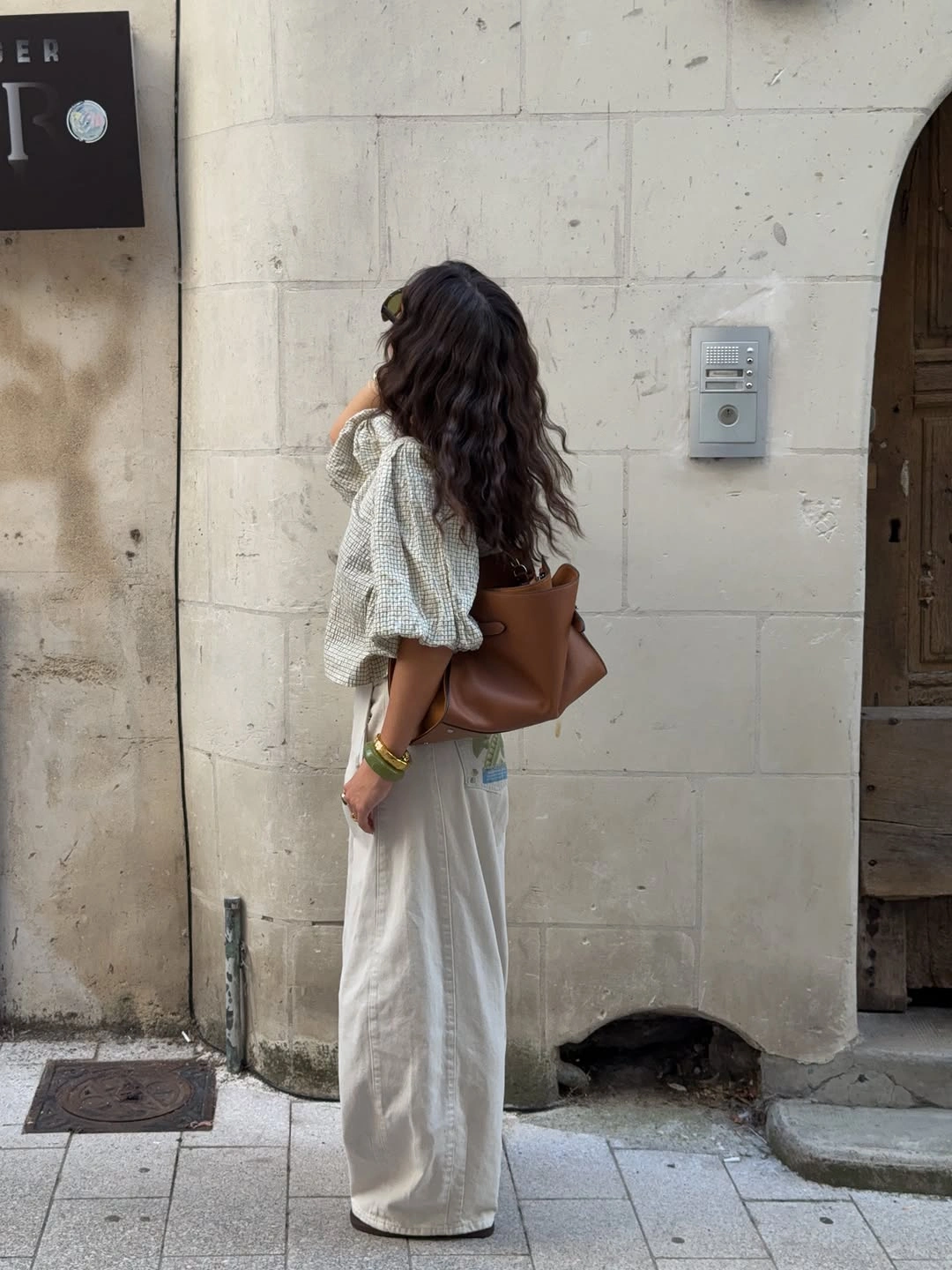 Checked puff sleeve blouse cream trousers and brown bag