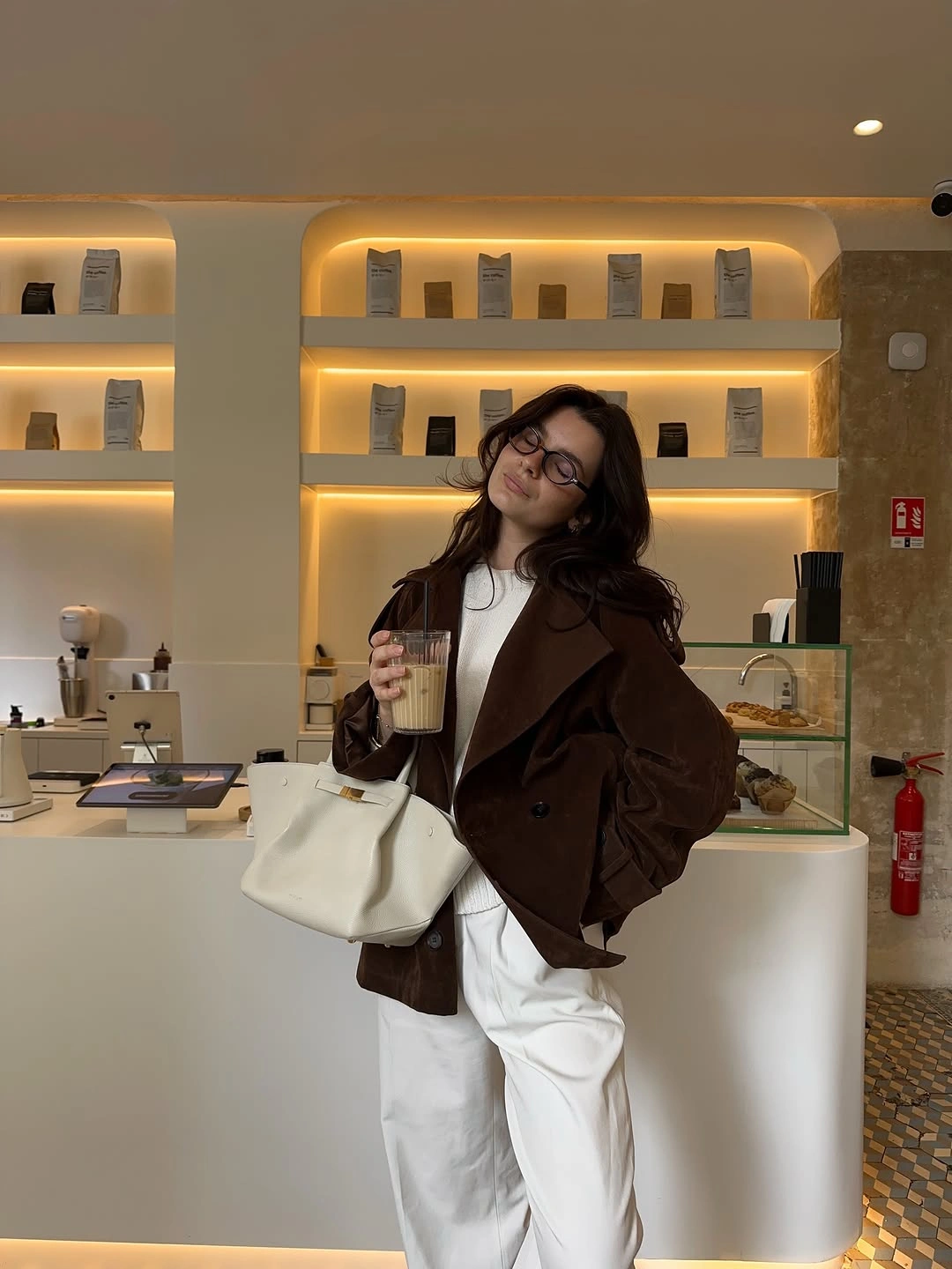 Dark brown blazer white top trousers and handbag