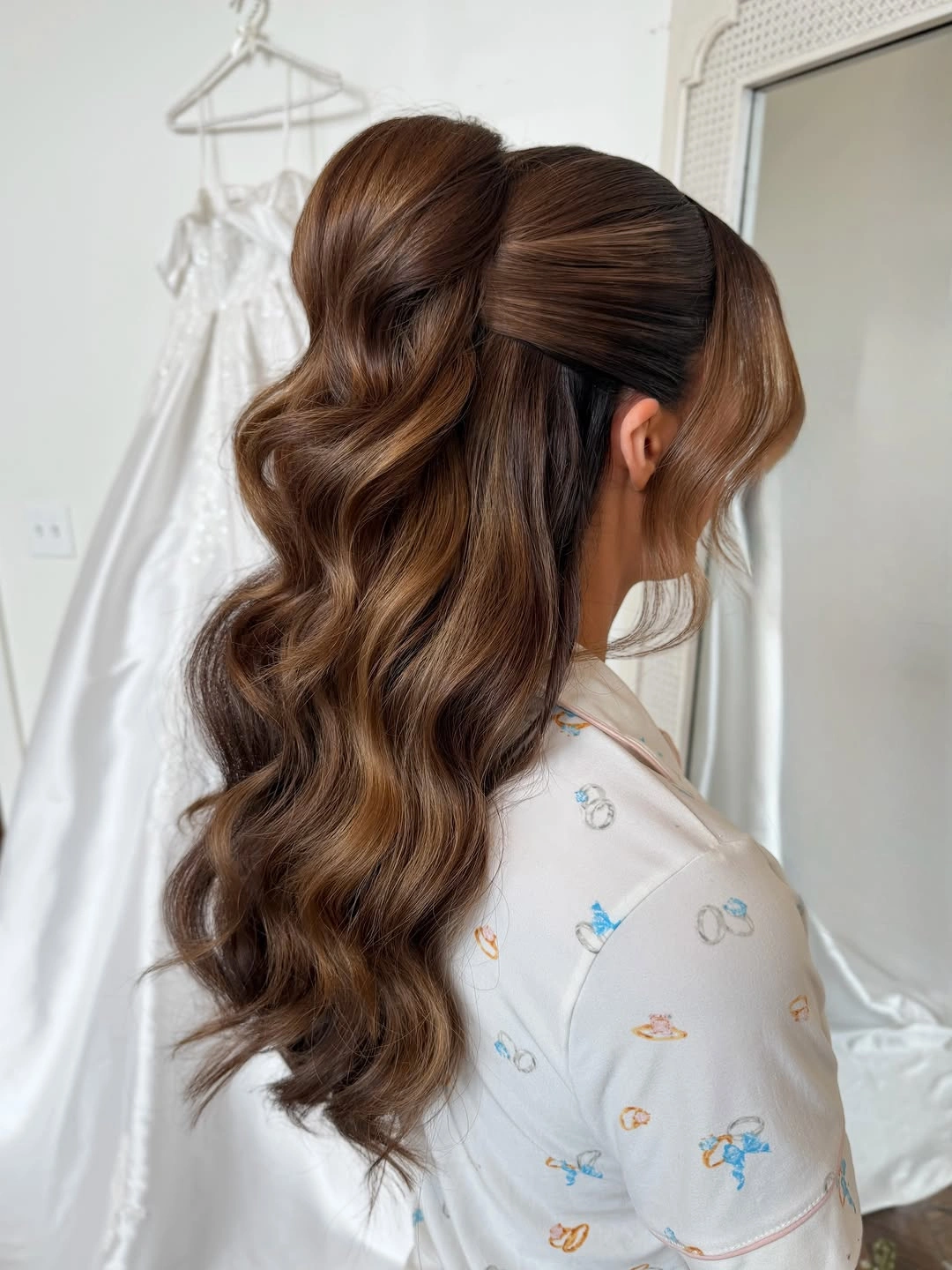 Long chestnut brown hair in a voluminous half up wavy hairstyle