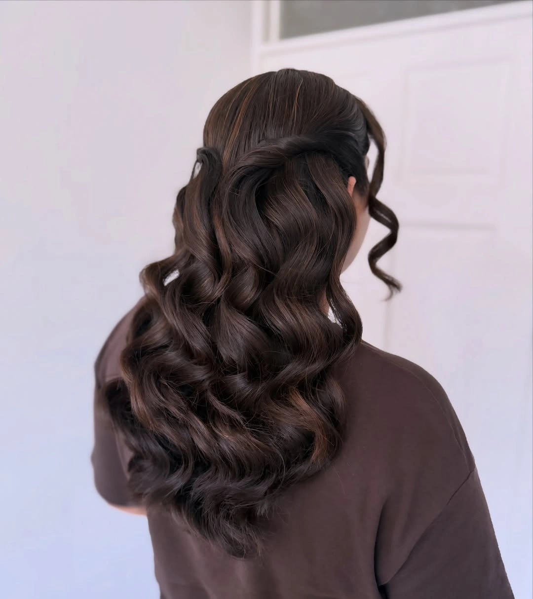 Dark espresso brown hair with folded half up sections and cascading waves