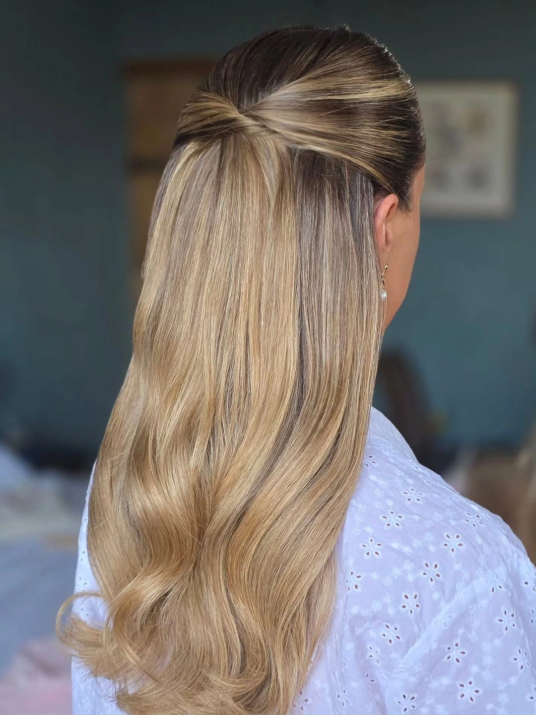 Long creamy champagne blonde hair with darker roots and half up twist