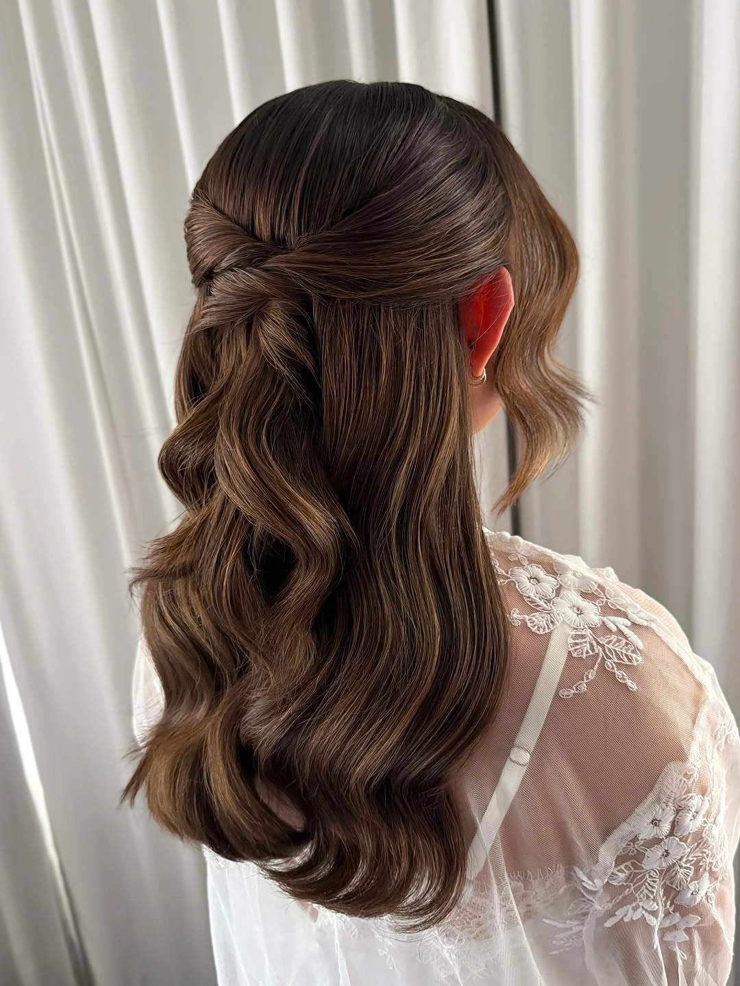 Long chocolate chestnut brown hair with twisted half up sections and glossy waves