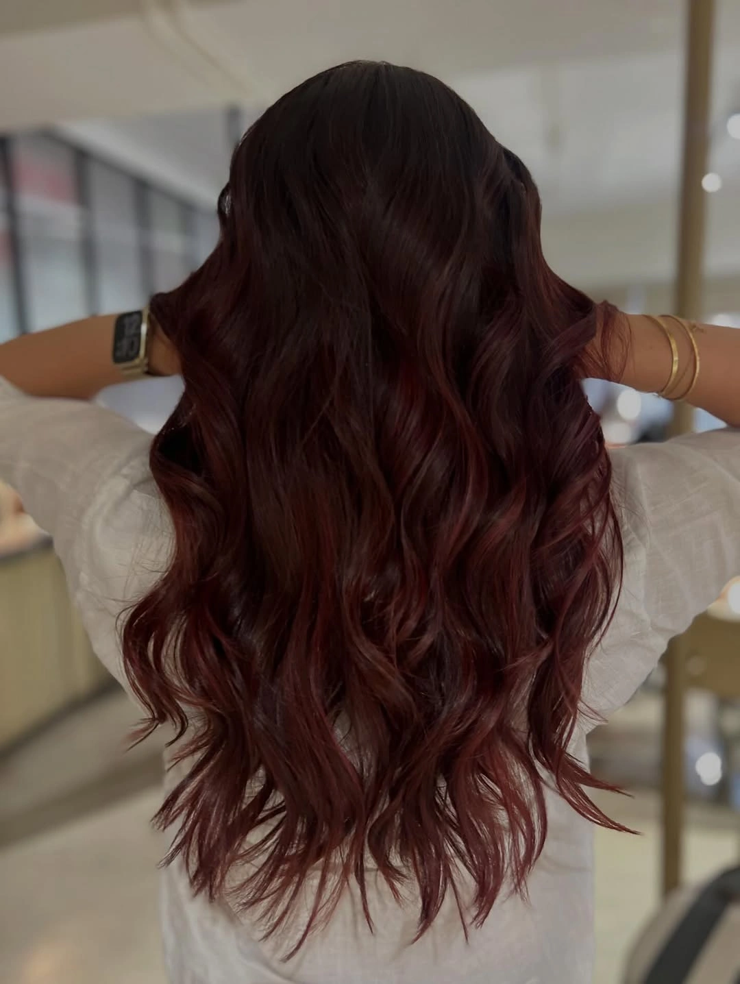 Very long dark burgundy hair with black cherry roots and berry red waves