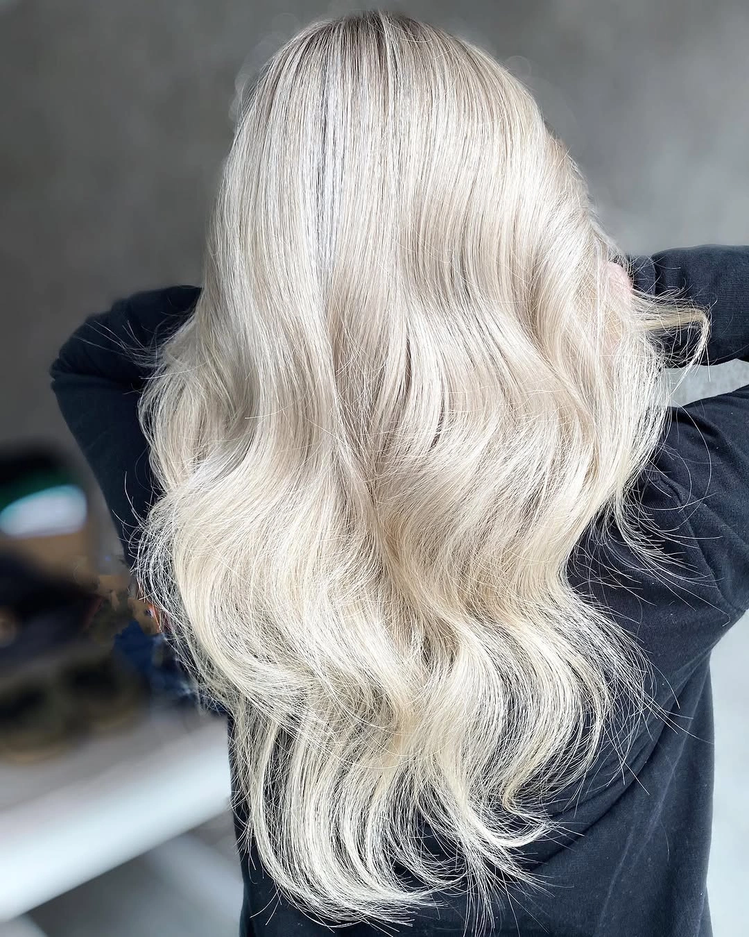 Long icy platinum blonde hair with pale creamy tones and loose waves