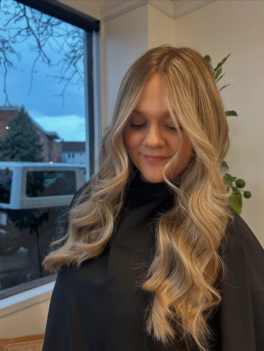 Long honey beige blonde hair with golden waves and lighter face framing strands