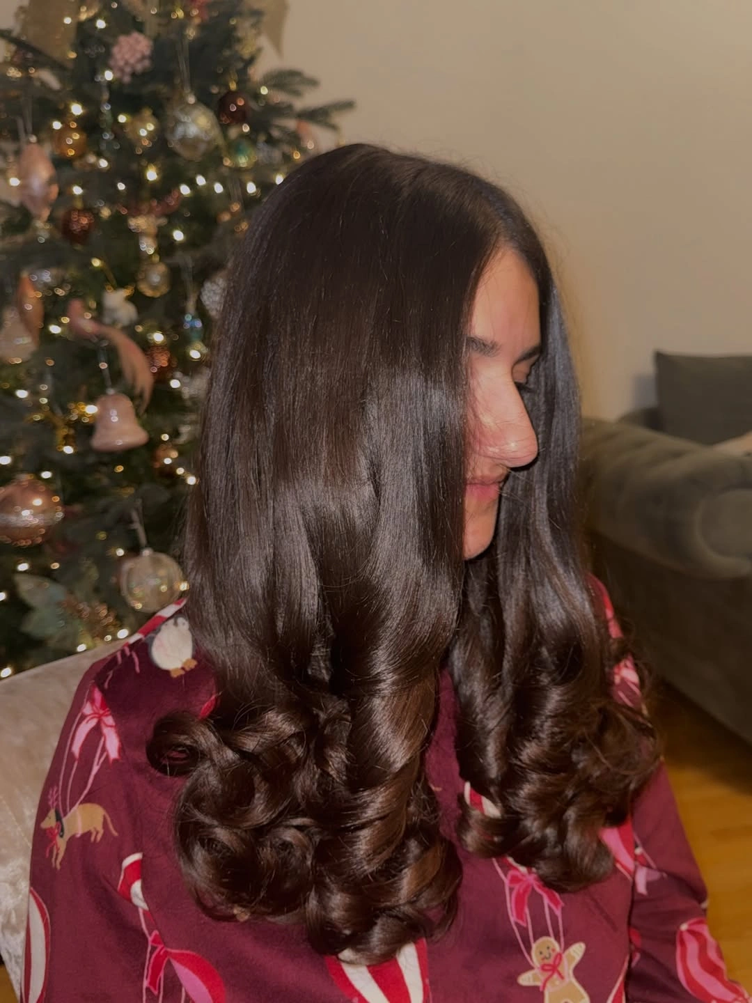 Dark chocolate brown hair with smooth upper lengths and defined curled ends