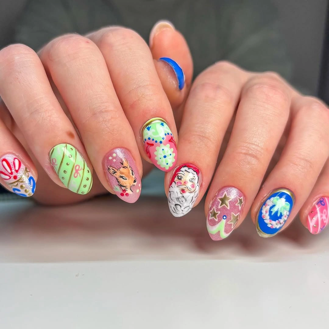 Almond nails featuring Santa, reindeer, gold stars, green patterns, and blue decorations