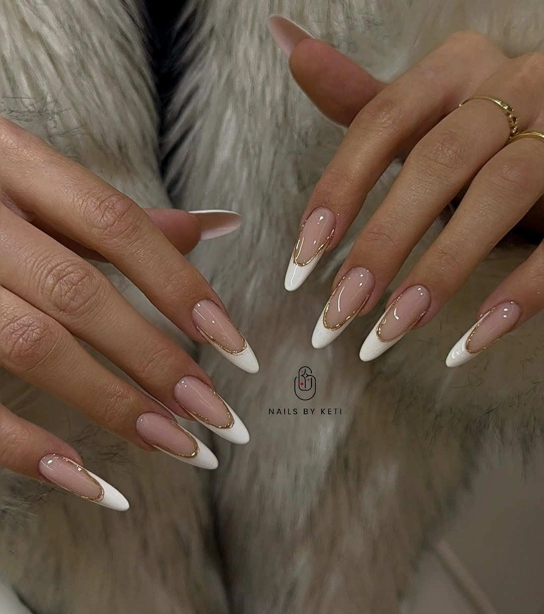 Long almond nails with white French tips and fine gold edging