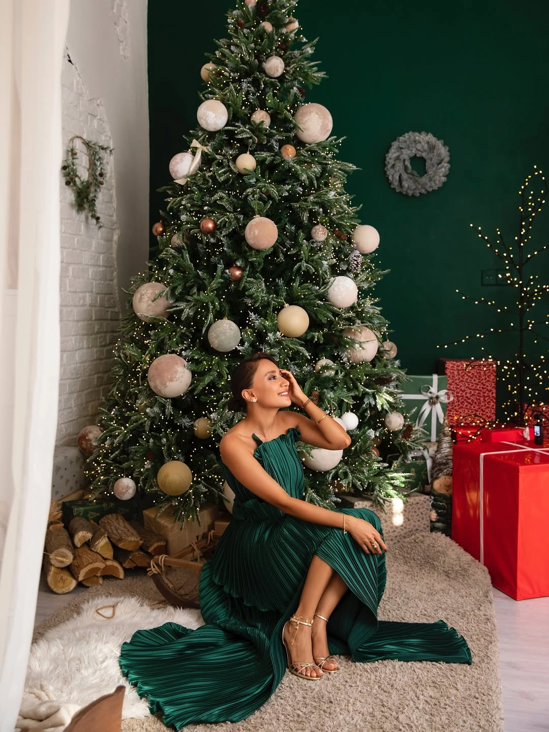 Emerald pleated strapless gown with metallic-tone strappy heels