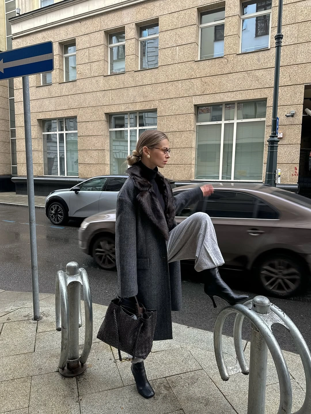 Charcoal coat with shimmering silver-gray trousers and black boots