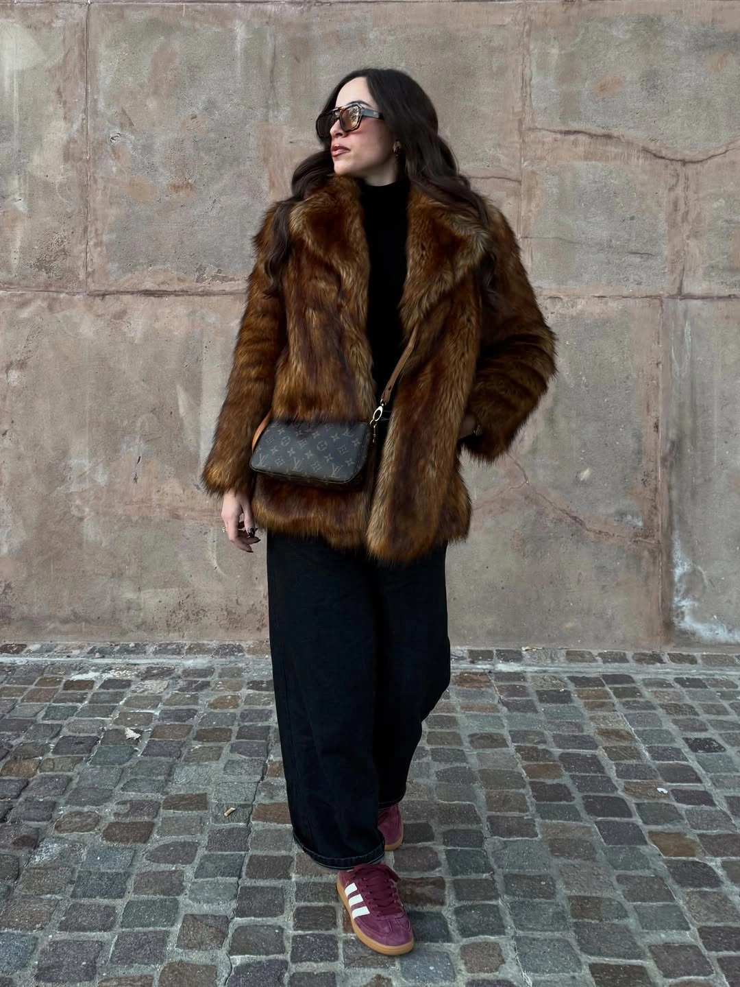 Brown textured jacket with black trousers and burgundy sneakers