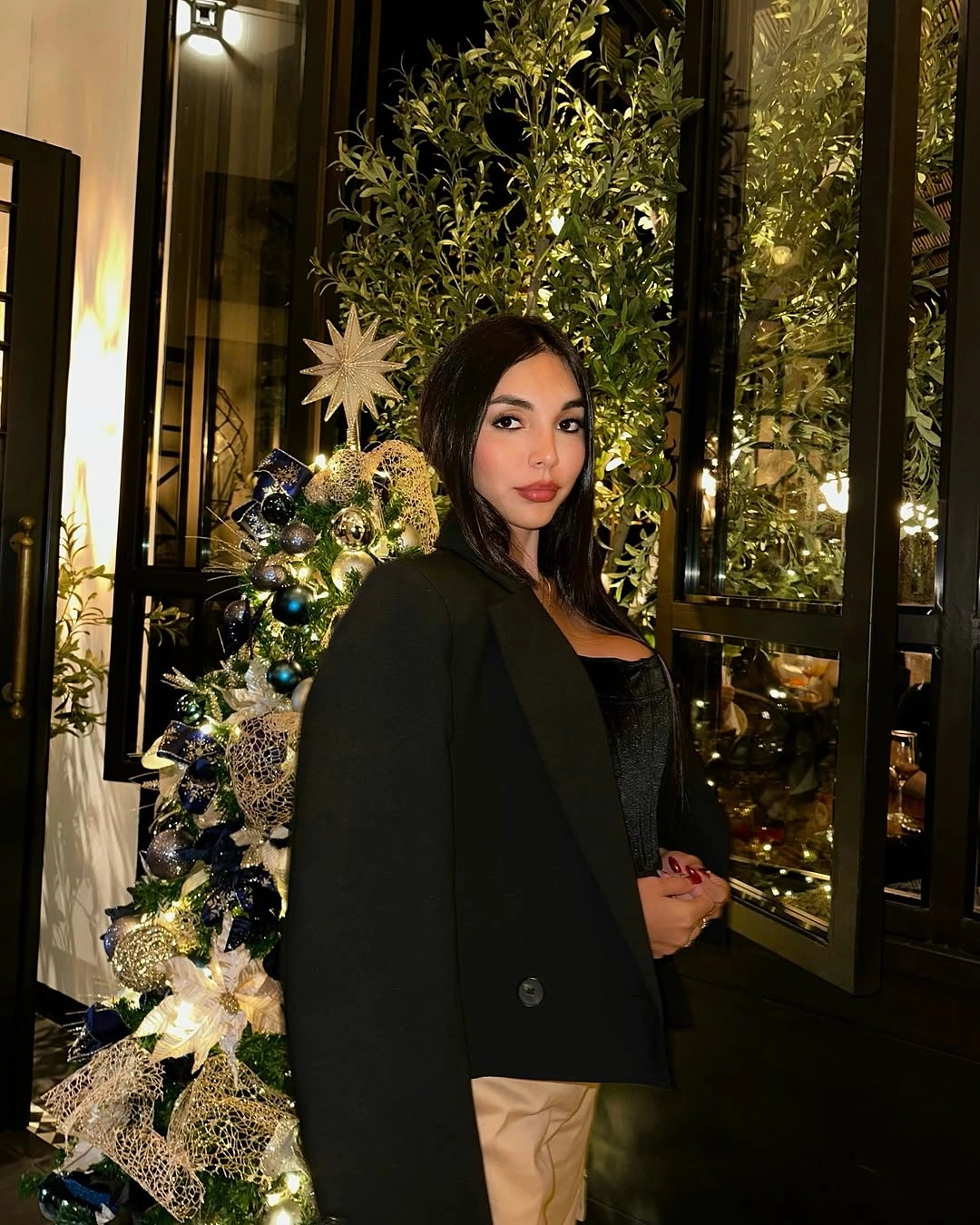 Black blazer over light-catching black top with warm beige below