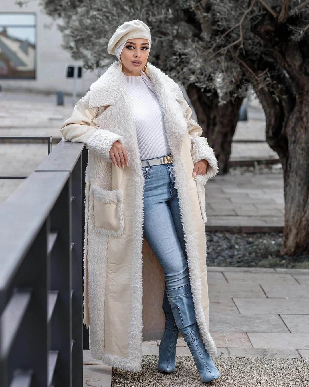 Cream shaggy-trim coat with light jeans and blue knee-high boots