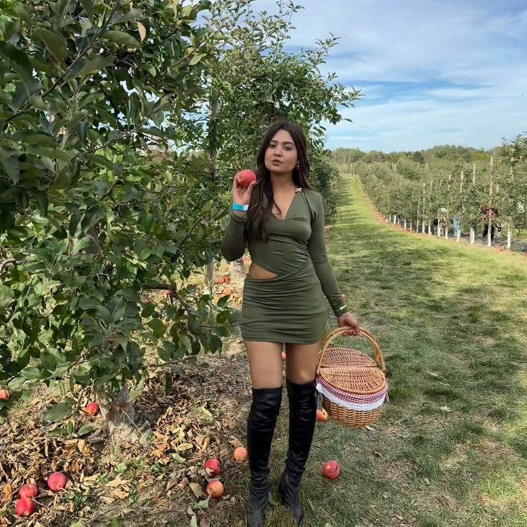 Olive mini dress with black over-the-knee boots and wicker basket