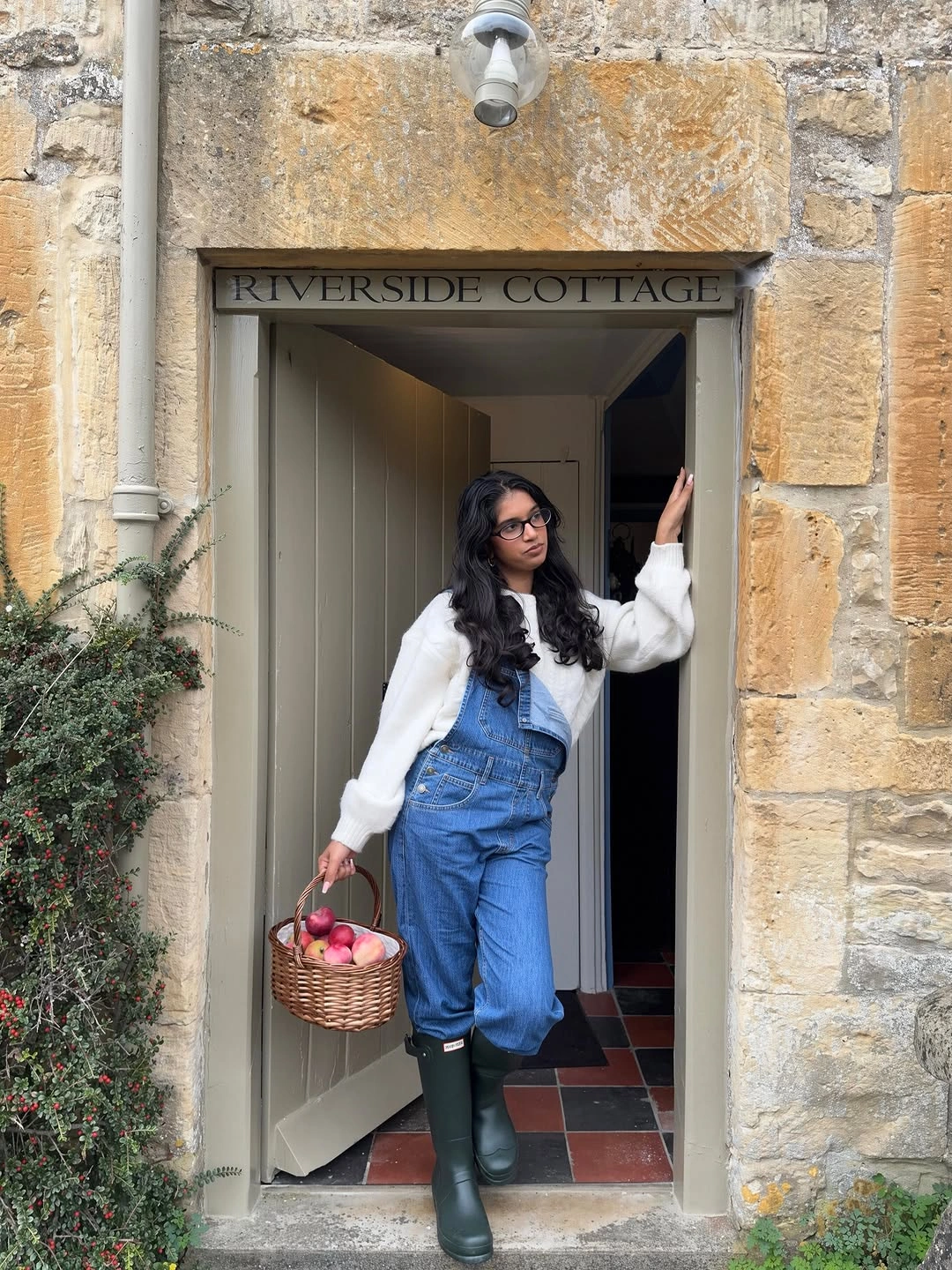 Denim overalls with white top and tall green rubber boots