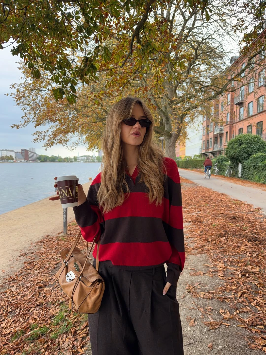 Red and dark brown striped top with loose dark trousers