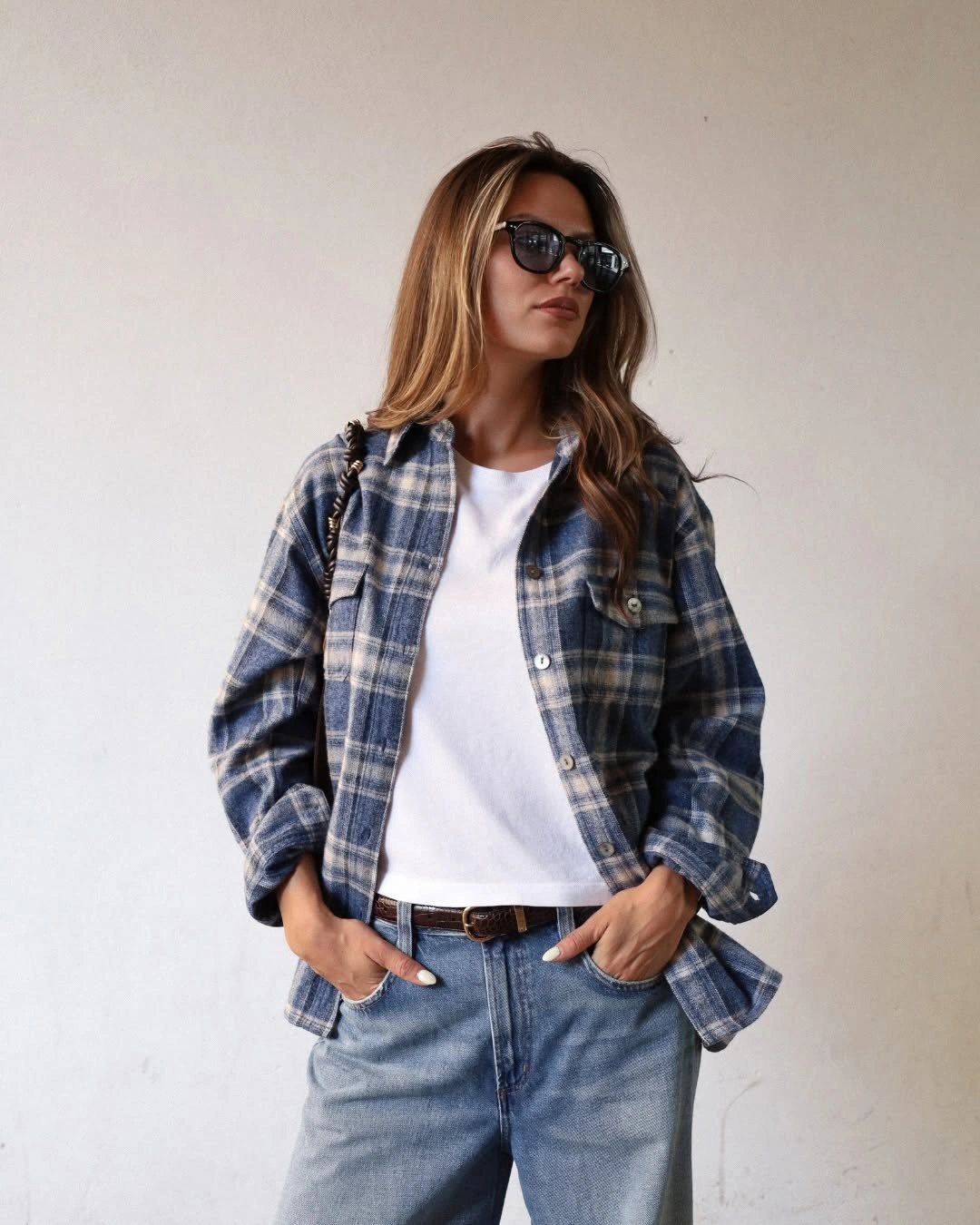 Plaid overshirt with white tee and relaxed blue jeans