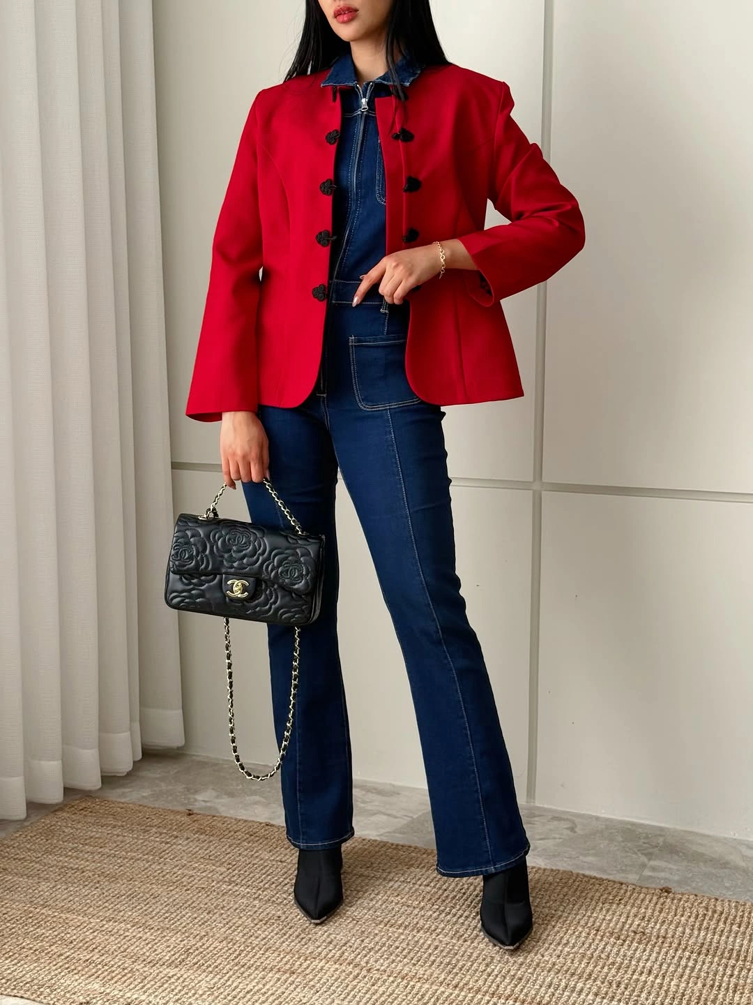 Red tailored jacket over dark denim shirt and indigo jeans