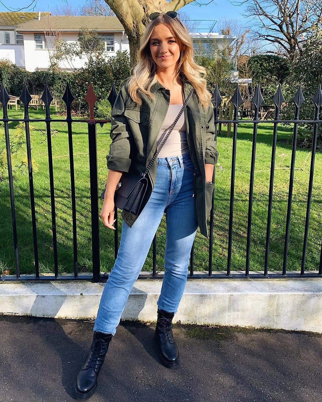 Olive utility jacket with light jeans and black ankle boots