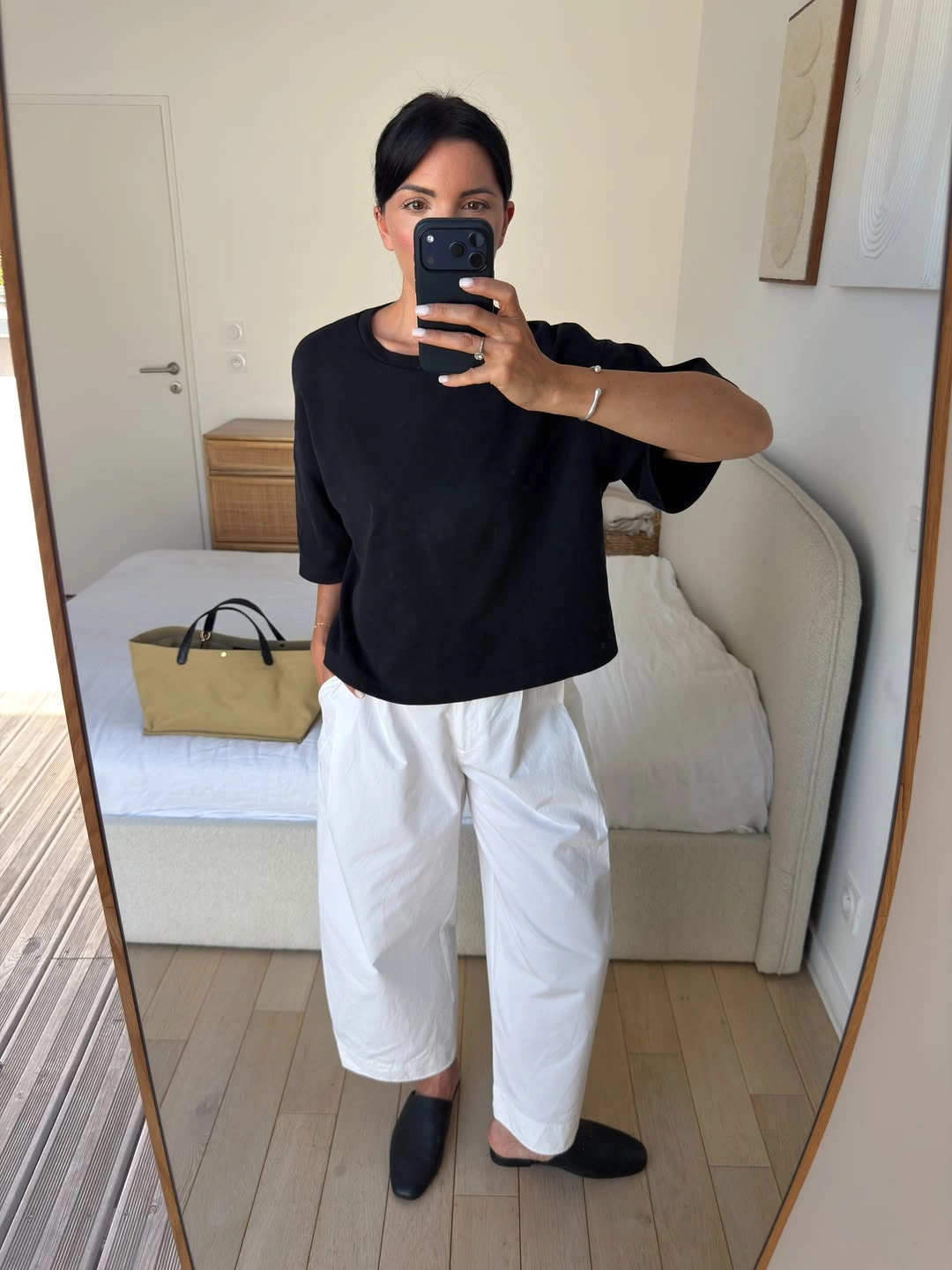 Boxy black short-sleeve top with wide white cropped trousers and black flats